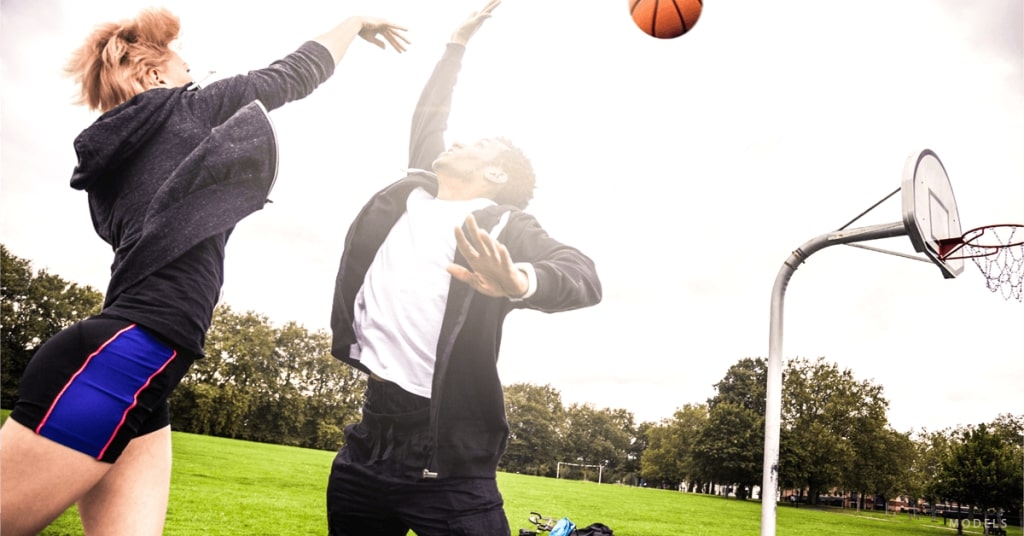 Couple (MODELS) playing basketball